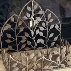 Interwoven leaves on metal can be used as wall or counter shelf